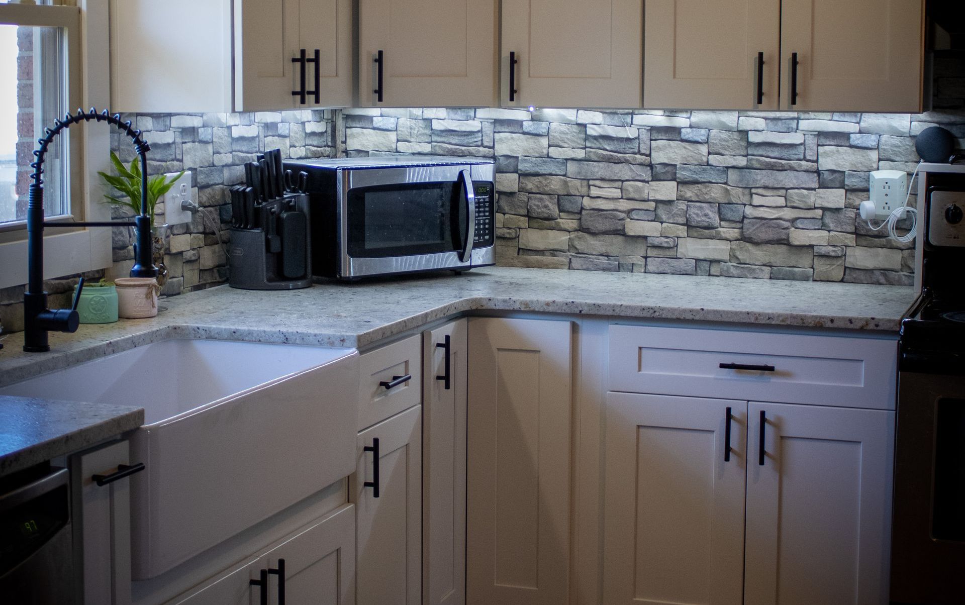 Granite countertops and white cabinetry in the finished Gallion kitchen